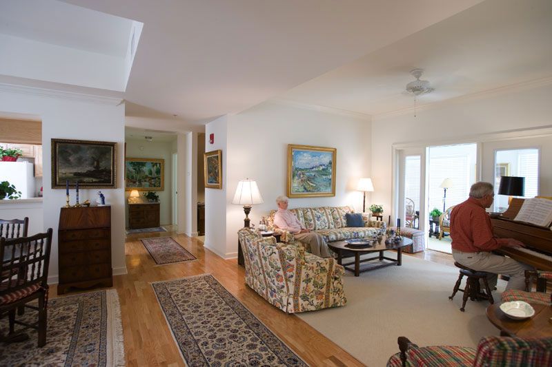 A cozy living room with elegant furnishings and artwork on the walls.