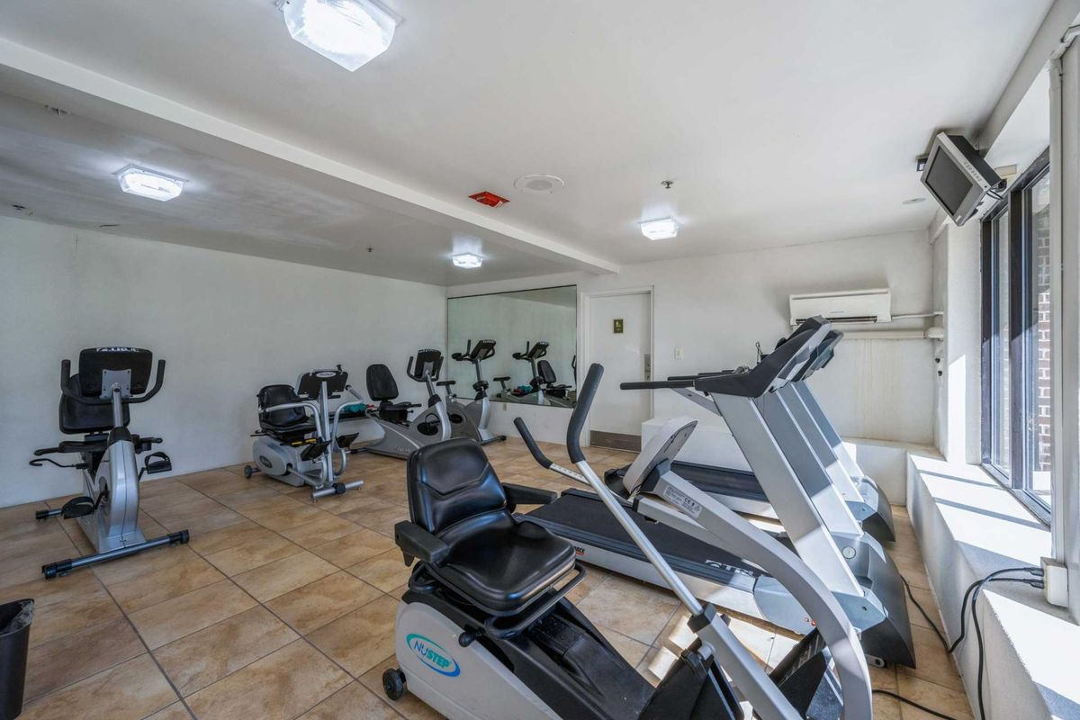 A well-equipped gym with treadmills and exercise bikes.