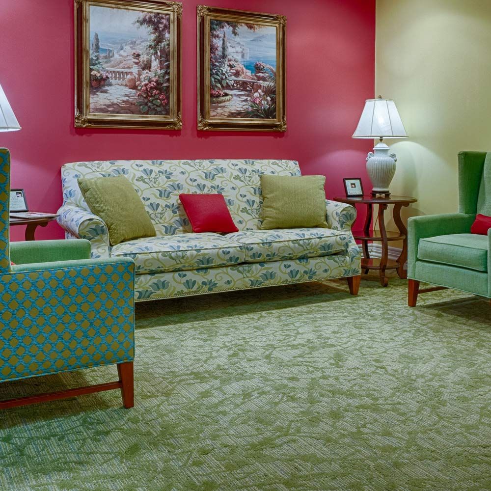 A cozy living room with patterned furniture and warm lighting.