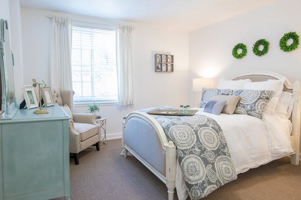 A bright and cozy bedroom with elegant decor and natural lighting.