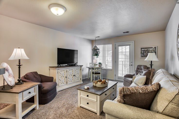 A cozy living room with a television, sofa, and coffee table.