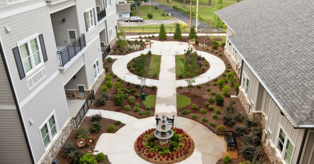 Aerial view of a landscaped courtyard with pathways and a central fountain.