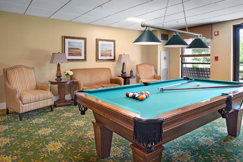Cozy game room featuring a pool table and comfortable seating.