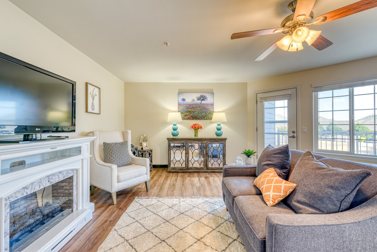 A cozy and elegantly designed living room with a sofa, armchair, and decorative elements.