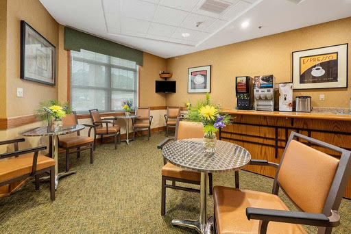 A cozy waiting area featuring comfortable seating and a coffee station.