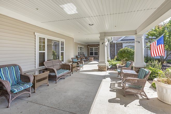 A spacious patio area with comfortable seating under a covered roof, perfect for relaxation.