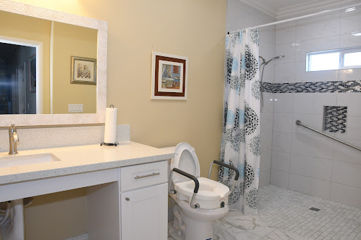 A modern and clean bathroom featuring a toilet, shower, and vanity.