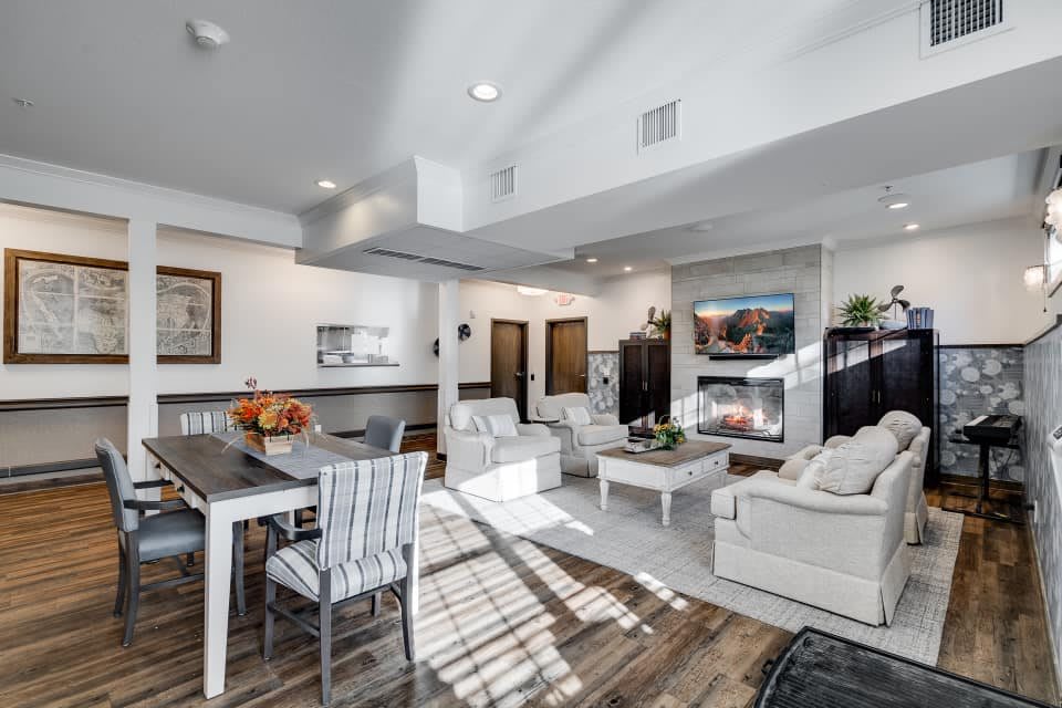 A modern open-concept living and dining area featuring a cozy fireplace, comfortable seating, and stylish decor.