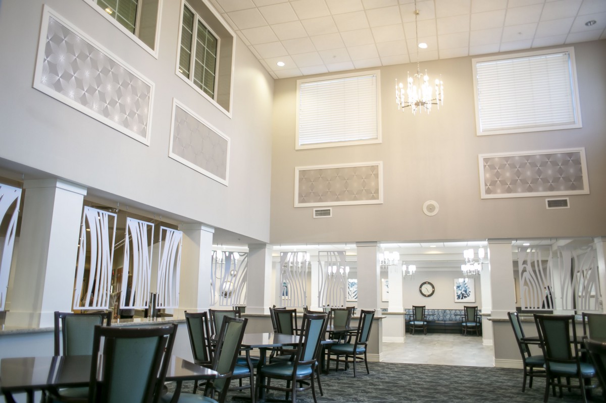 Modern lobby with high ceilings and dining furniture.