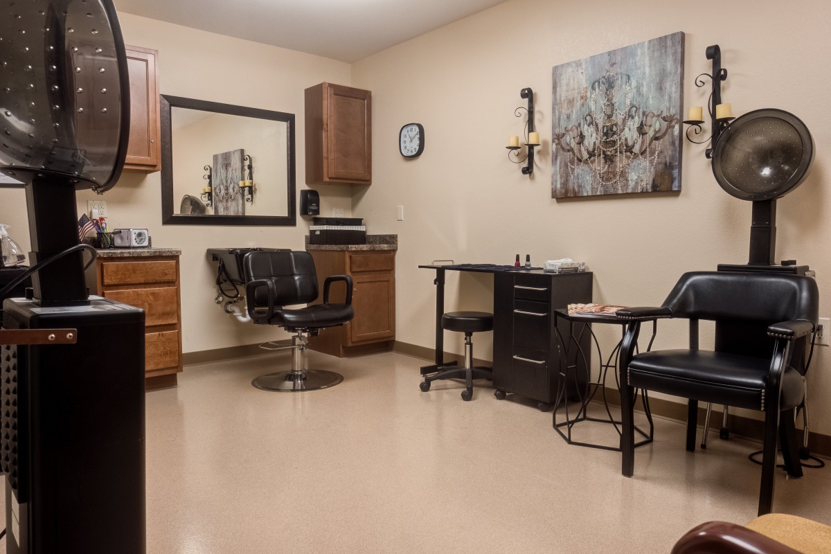 An interior view of a hair salon featuring chairs, mirrors, and beauty equipment.