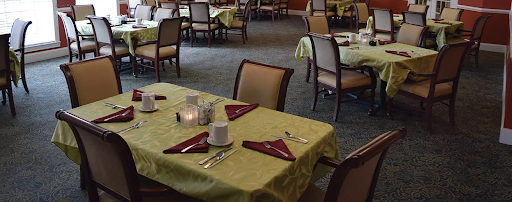 A spacious dining area featuring neatly arranged tables and chairs ready for guests.