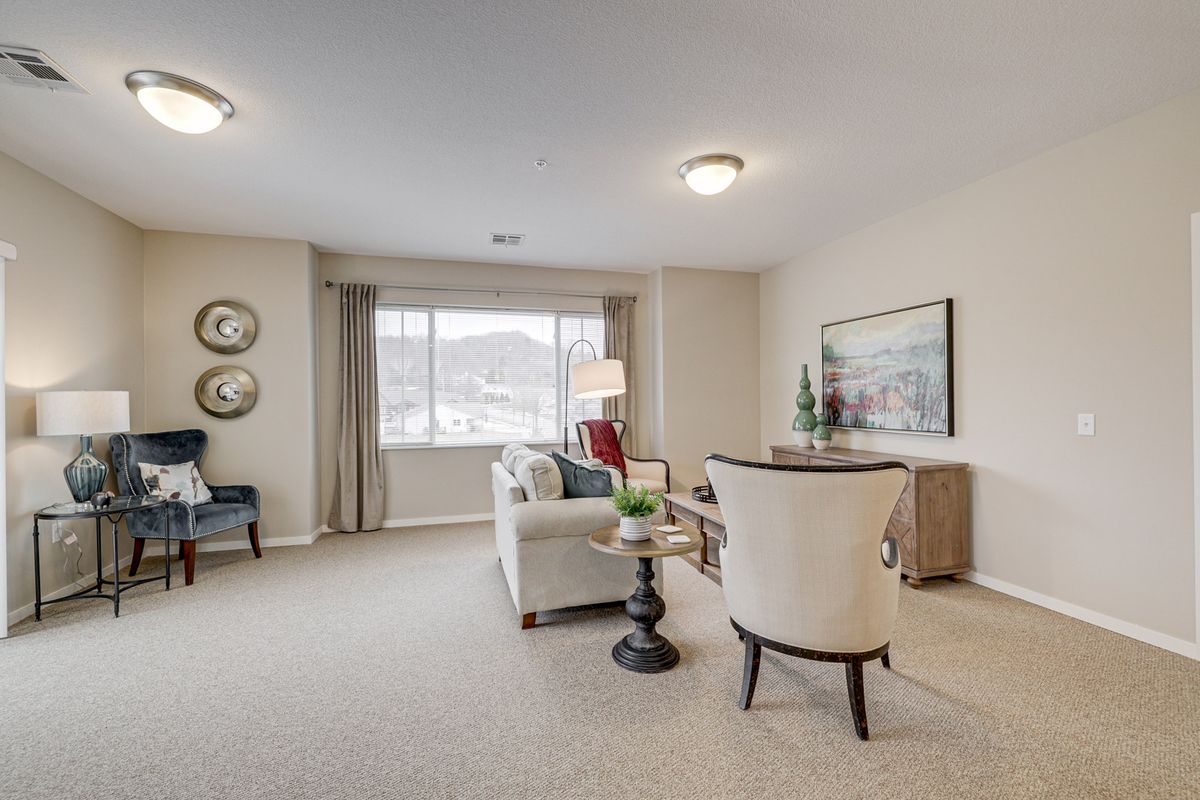 A well-lit living room featuring comfortable seating and stylish decor.