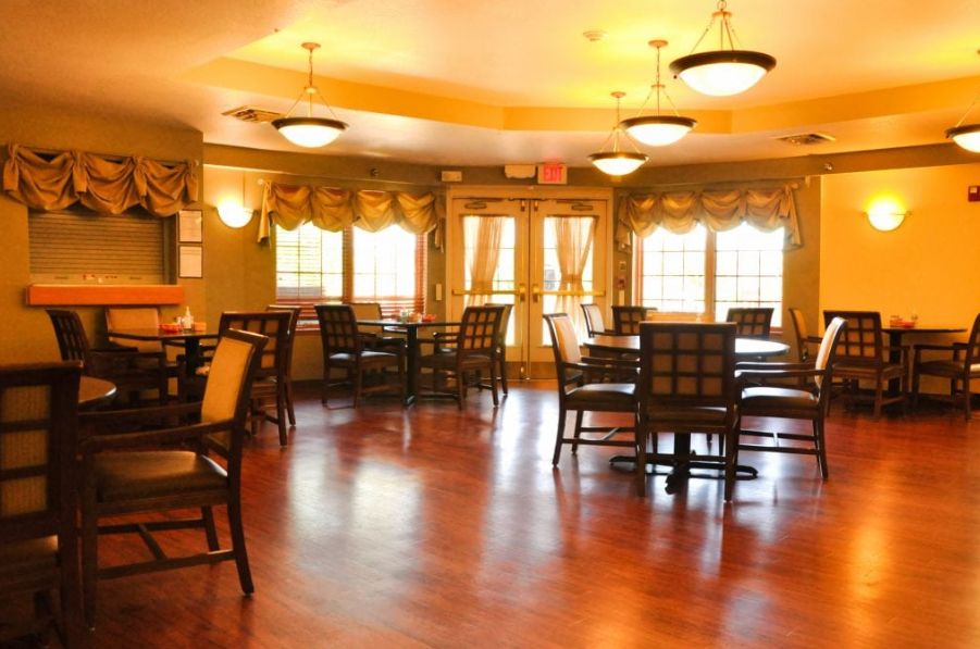 A cozy dining room with wooden floors and elegant lighting.
