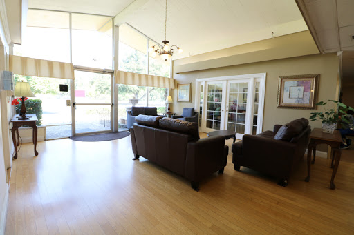 A spacious and inviting living room featuring comfortable sofas and ample natural light.