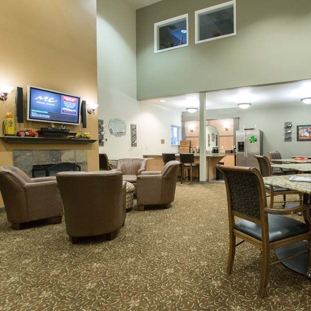 A cozy lounge area with comfortable seating and a television.