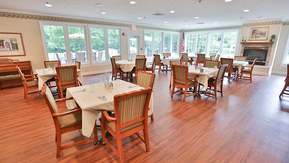 A bright and airy dining area with neatly arranged tables and chairs.