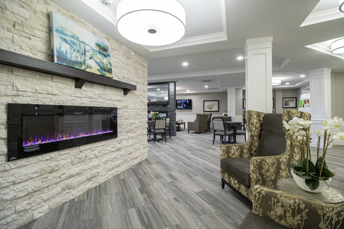 A modern living room with a stylish fireplace and comfortable seating.