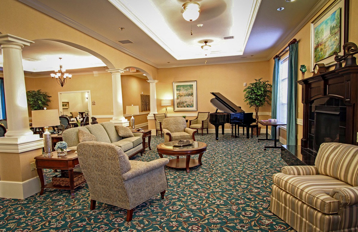 A cozy lounge area with comfortable seating and a grand piano.
