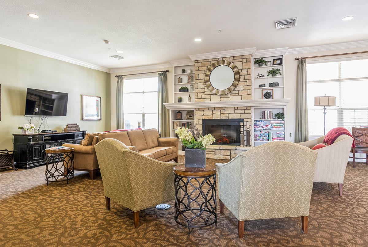 A cozy living room featuring a modern fireplace, comfortable seating, and elegant decor.