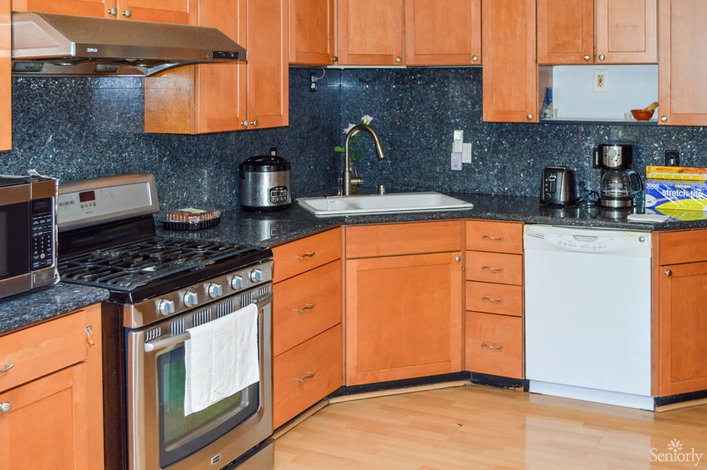A modern kitchen with wooden cabinets and various appliances.