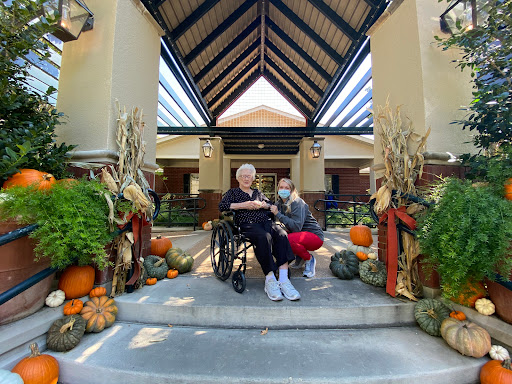 A heartwarming scene of companionship amidst festive autumn decorations.