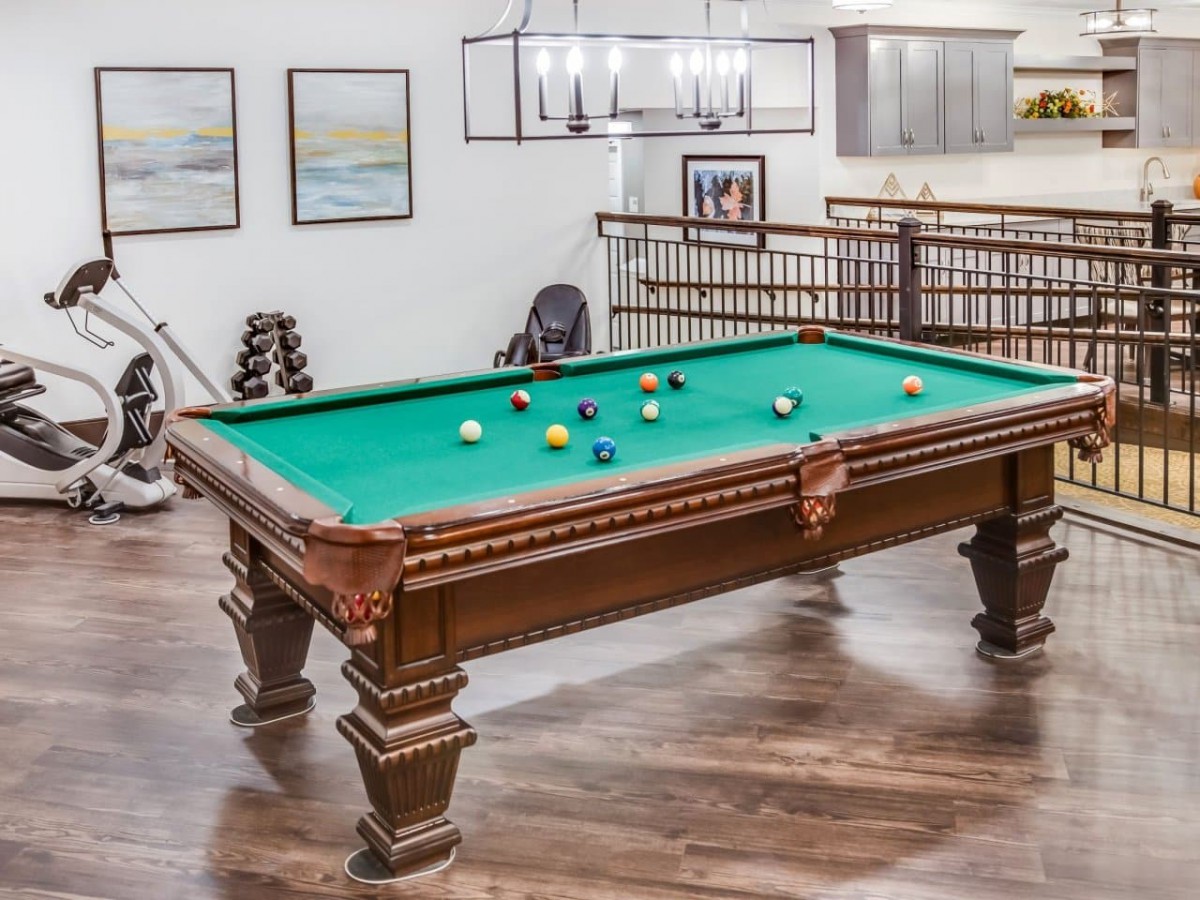 A classic pool table in a stylish game room setting.