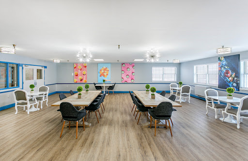 A modern meeting room featuring stylish furniture and vibrant artwork.