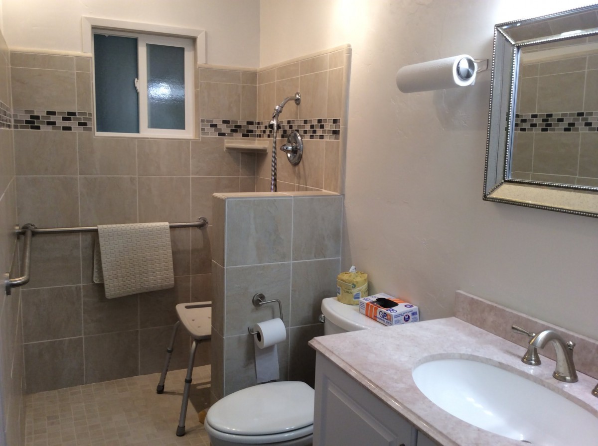 A well-organized bathroom with a shower, sink, and toilet.