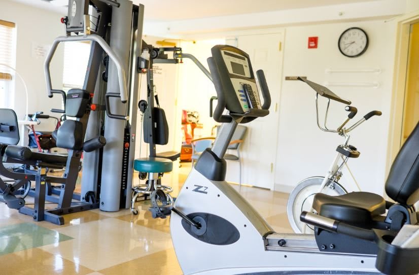A gym with various exercise equipment including a stationary bike.