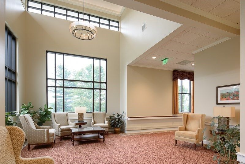 A spacious lobby area with ample seating and large windows providing natural light.