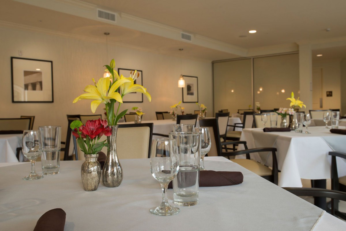An elegantly set dining table in a sophisticated restaurant interior.