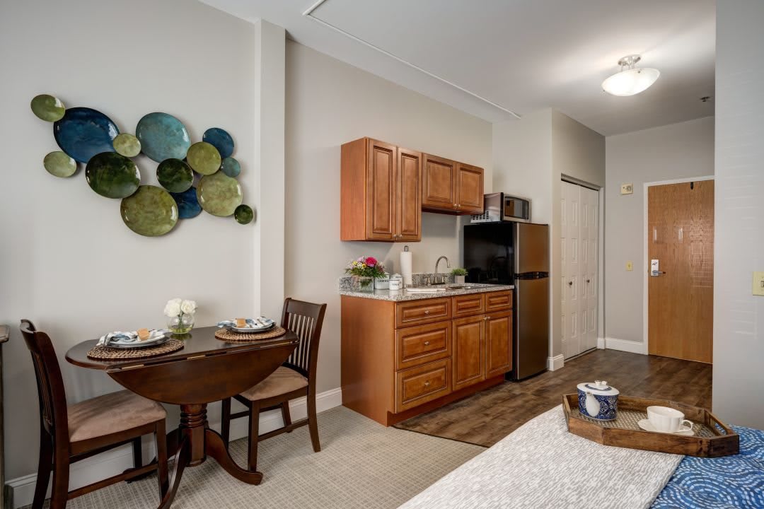 A cozy apartment kitchenette with a small dining area and modern decor.