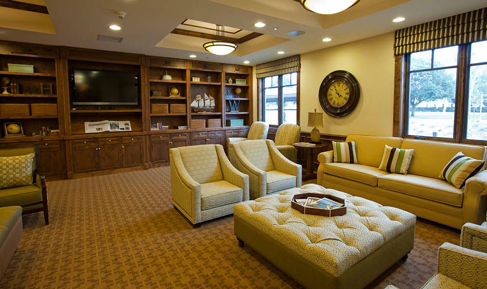 A cozy living room with plush seating and built-in bookshelves.