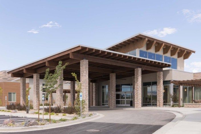 A modern commercial building with a large entrance and contemporary architectural design.