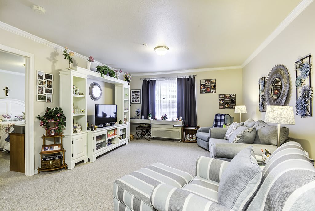 A cozy living room with comfortable seating and a neatly arranged entertainment center.