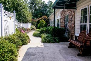 A landscaped garden with a pathway next to a brick building.