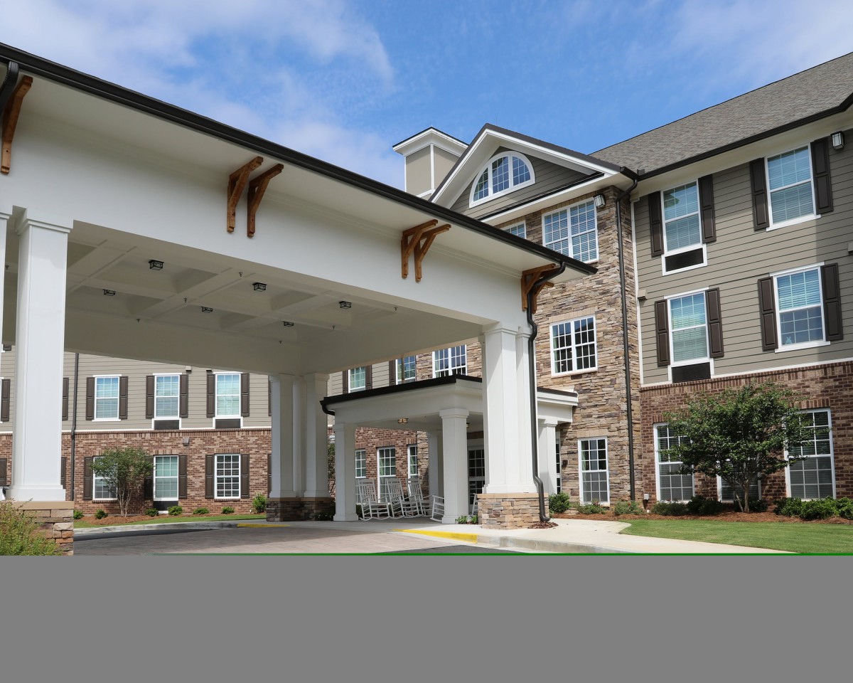 A modern residential building with a covered entrance.