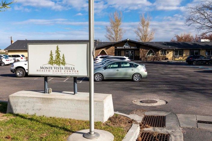 A car parked in front of a building with a sign reading 'Aspen View Rest Dental Care Center'.