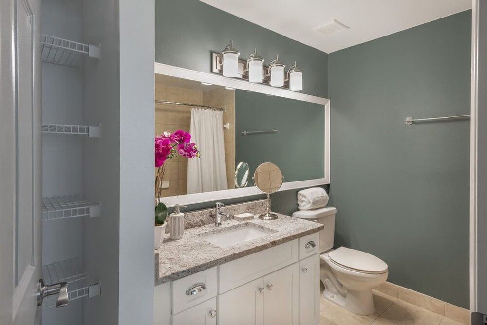 A modern bathroom with elegant decor and a large mirror.