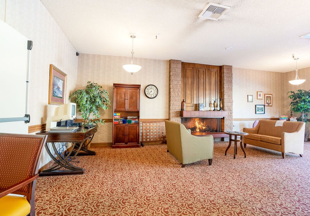 A cozy lobby area with comfortable seating and a fireplace.