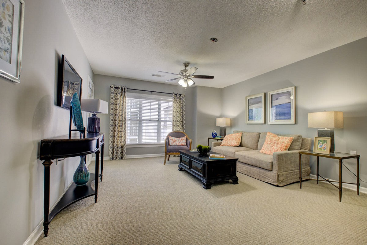 A stylish and cozy living room with a sofa, coffee table, and wall art.
