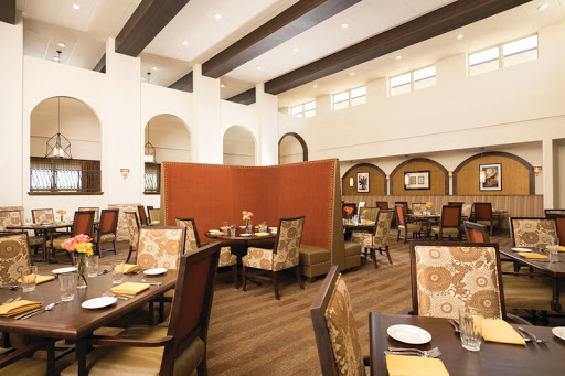 A spacious and elegantly designed dining area with comfortable seating and modern decor.