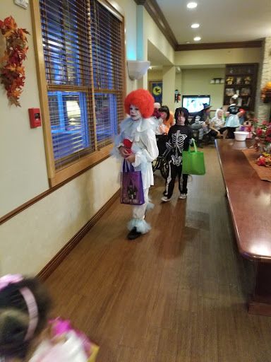 Children in Halloween costumes participating in a festive celebration.