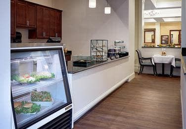 Interior view of a cafe with display cases and seating area.