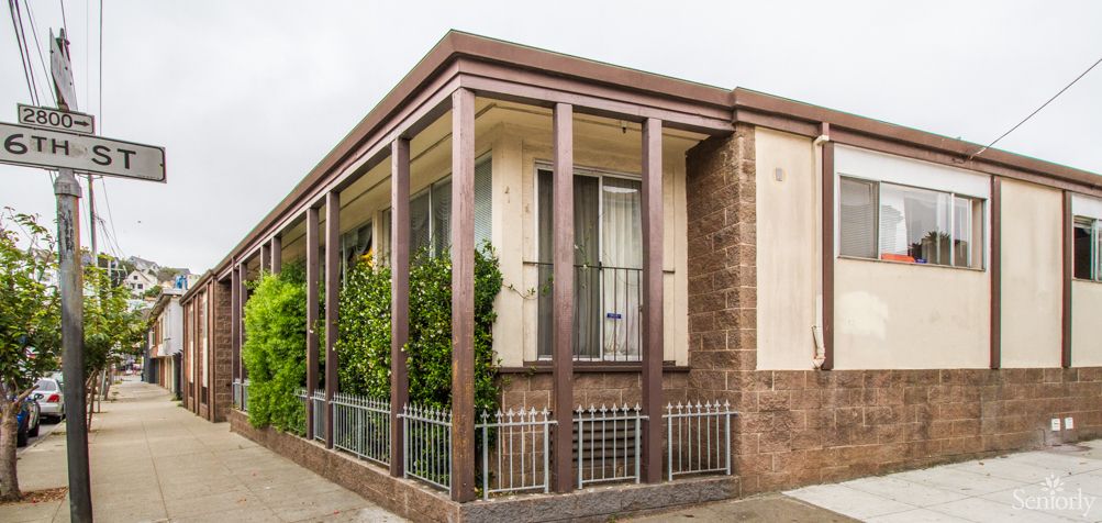 A modern house with large windows and a decorative fence.
