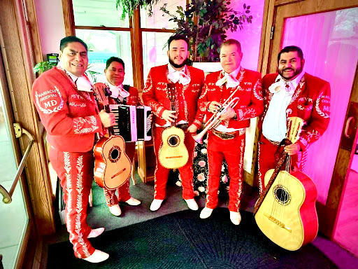 A lively mariachi band dressed in vibrant red outfits, showcasing their instruments in a festive setting.