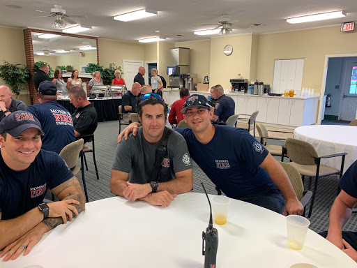 A group of firefighters enjoying their time together in a dining area.
