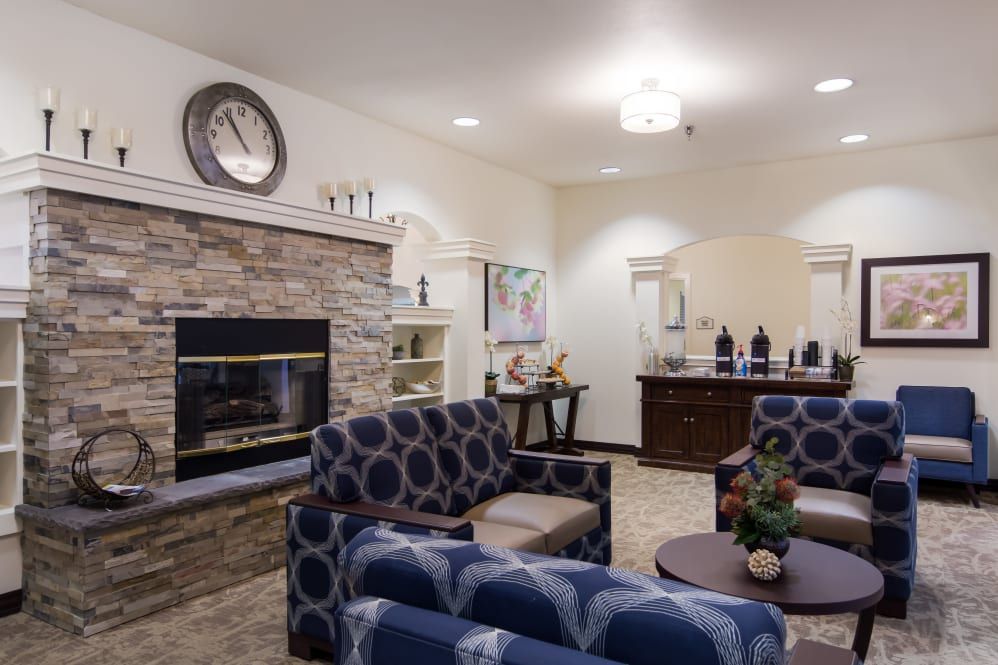 A cozy and modern living room with a stone fireplace, stylish furniture, and elegant decor.