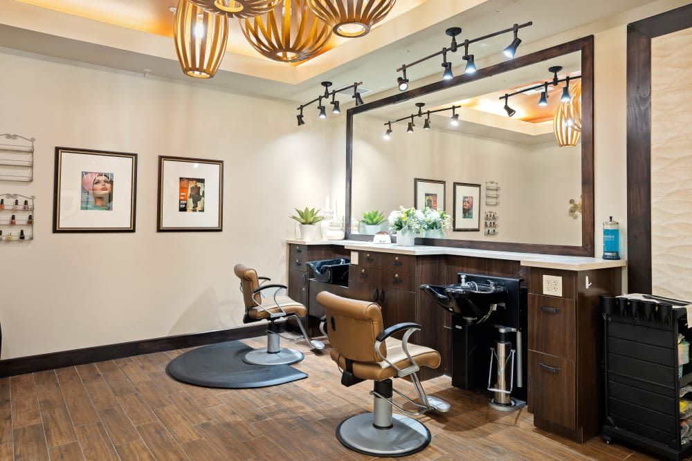 A modern hair salon with stylish decor and comfortable seating.
