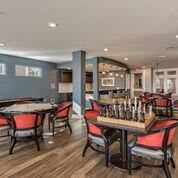 A modern lounge area featuring a chess table and comfortable seating.